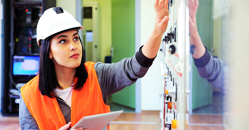 female utility worker checking switches_Canva.png