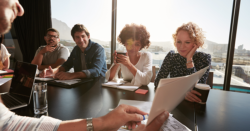 Group of employees listening to presentation_Canva.png