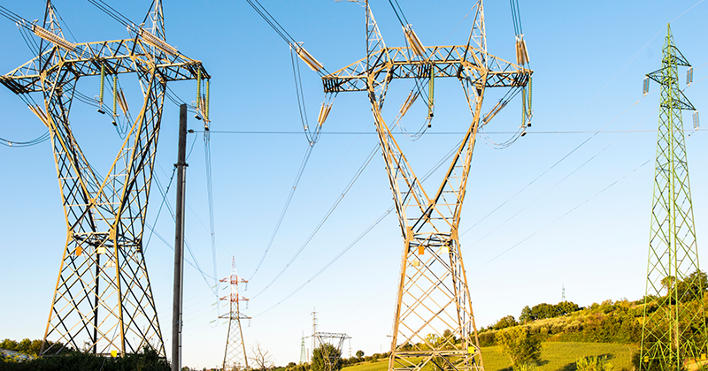 Two transmission lines on grassy hill_Canva.png