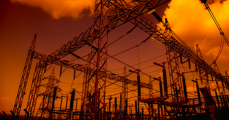 Power substation against orange sky_Canva.png