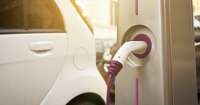 EV with purple charger and sun flare_Canva.png
